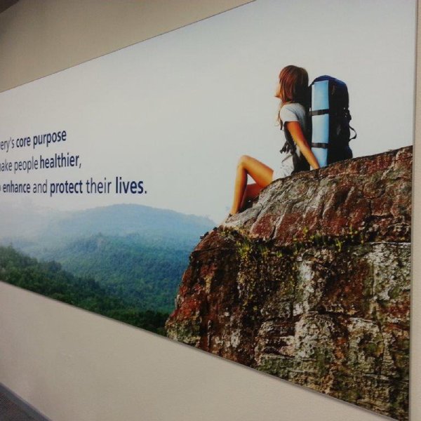 Wall-mounted fabric wall frame with seamless SEG graphics for interior branding.
