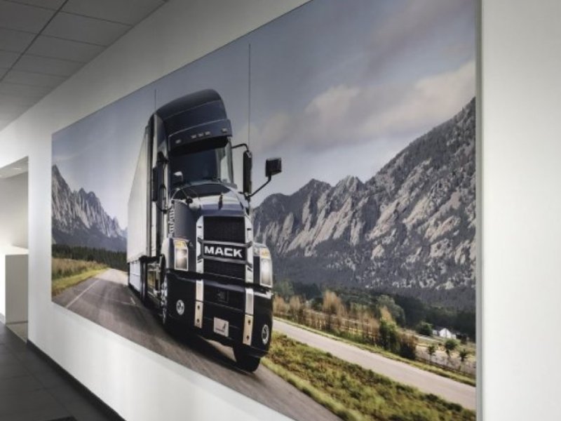 Wall-mounted fabric wall frame with seamless SEG graphics for interior branding.
