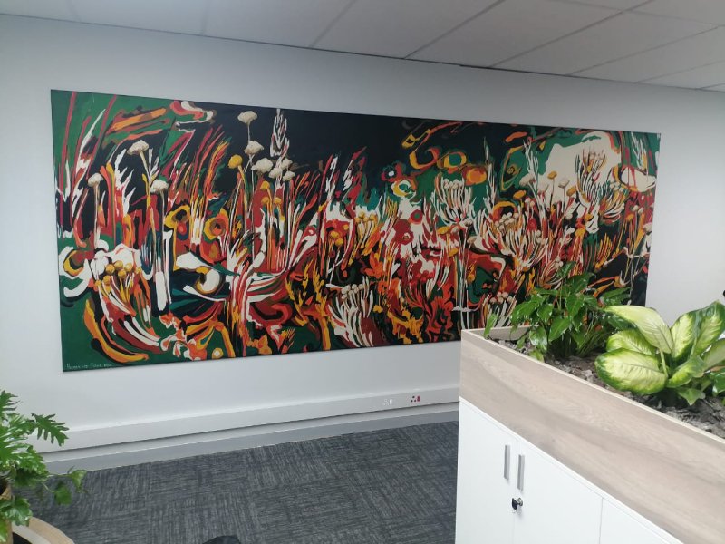 Wall-mounted fabric wall frame with seamless SEG graphics for interior branding.
