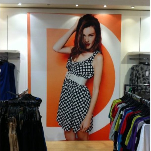 Wall-mounted fabric wall frame with seamless SEG graphics for interior branding.
