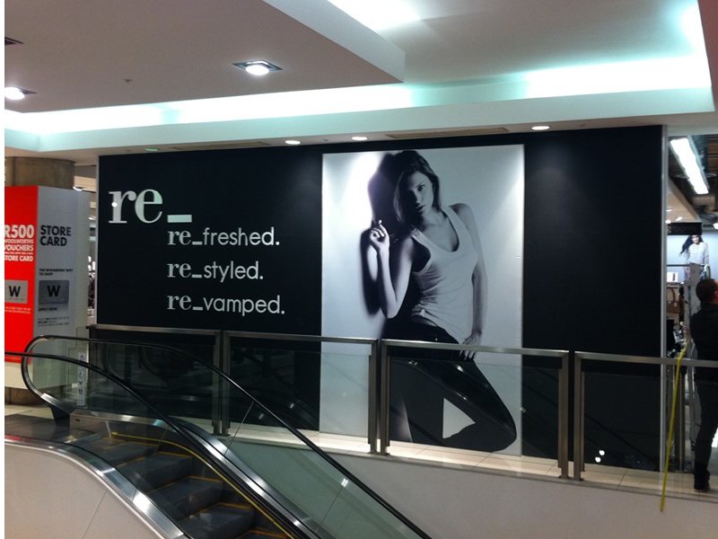 Wall-mounted fabric wall frame with seamless SEG graphics for interior branding.
